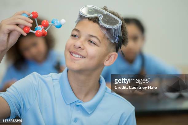preteen boy smiling in stem science class - charter school stock pictures, royalty-free photos & images