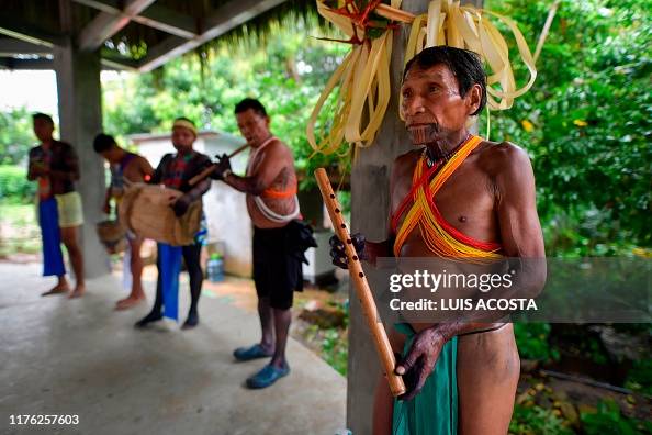 Embera Instruments Embera indigenous play instruments during the preparation of a giant ...