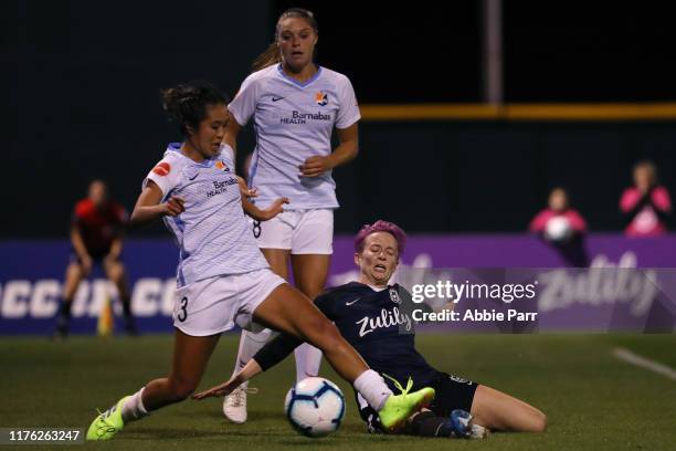 Caprice Dydasco of Sky Blue FC collides with Megan Rapinoe of Seattle Reign FC in the second half during their game at Cheney Stadium on September...