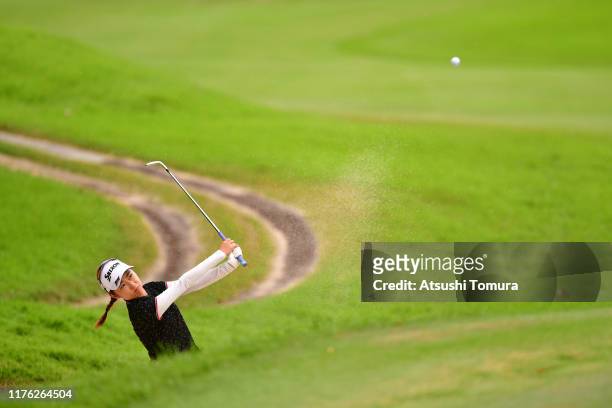 Amateur Yuka Yasuda of Japan hits out from a bunker to make a chip-in eagle on the 15th hole during the final round of the Descente Ladies Tokai...