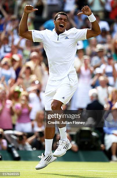 Jo-Wilfried Tsonga of France celebrates after winning his quarterfinal round match against Roger Federer of Switzerland on Day Nine of the Wimbledon...