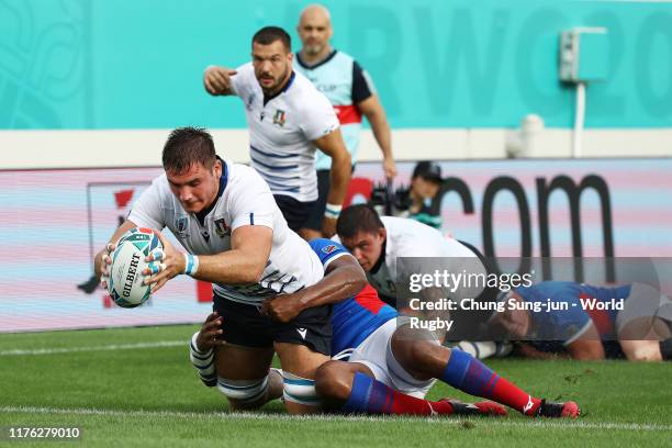 Jake Polledri of Italy grounds the ball to score his side's fifth try during the Rugby World Cup 2019 Group B game between Italy and Namibia at...