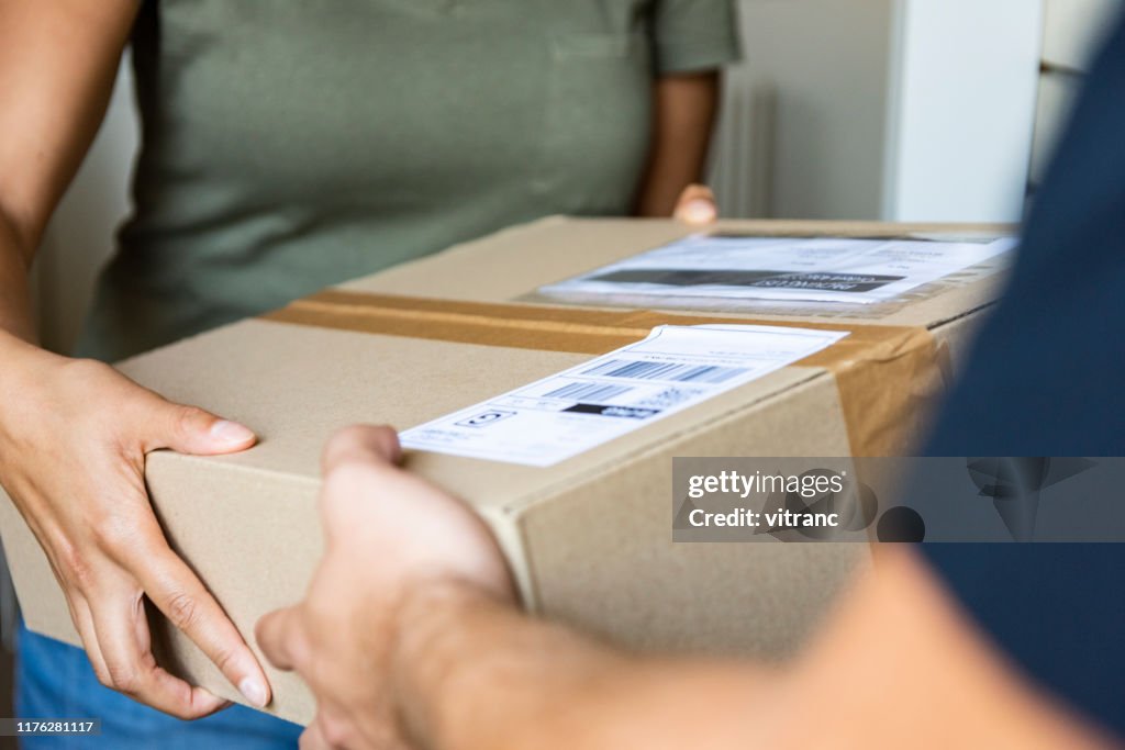 Client Delivery Home Delivery Of A Box To The Client High-Res Stock Photo - Getty Images