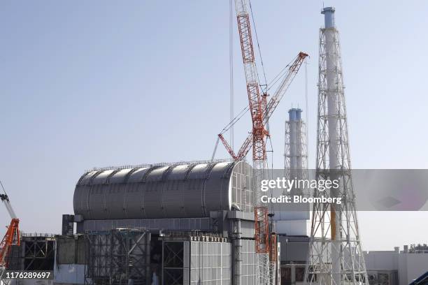 The Unit 3 reactor building stands near cranes and exhaust stack during a media tour of Tokyo Electric Power Co's Fukushima Dai-Ichi nuclear power...