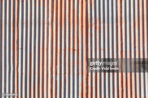 grey and orange corrugated iron panels - tool shed wall spaces stockfoto's en -beelden