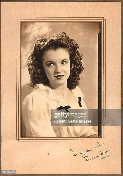 : The vintage portrait of Norma Jean Dougherty, also known as actress Marilyn Monroe, with a rare autograph and dedication "To my dear sister," is on...