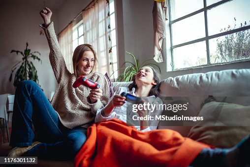 Mother and daughter playing video games Mother and daughter playing video games