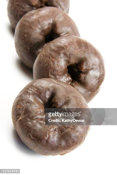 yummy chocolate donuts on a white background. - chocoladedonut stockfoto's en -beelden