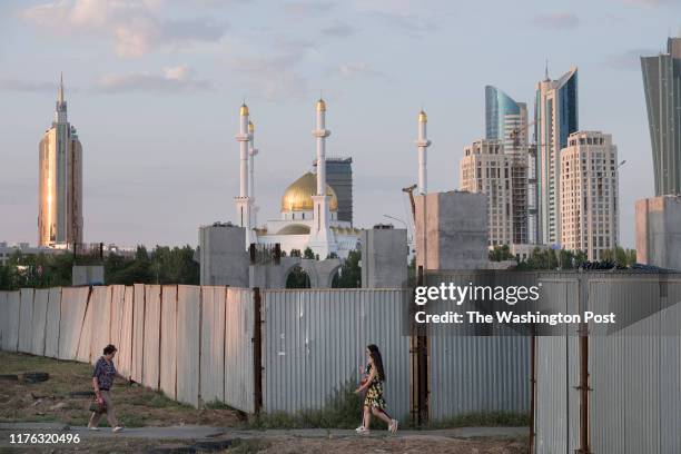 People walk past the abandoned, Chinese-funded LRT project in Nur-Sultan. The project is part of Chinas One Belt, One Road initiative aimed at...