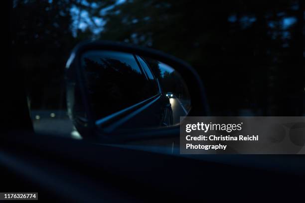 car following another car at night - following car stock pictures, royalty-free photos & images