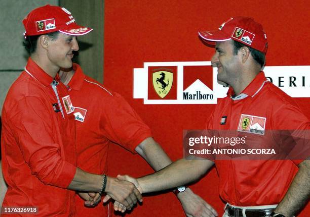 German race car driver Michael Schumacher , greets Brazilian teammate Ruben Barrichello at a press conference in San Pablo, Brazil, 29 March 2001. El...