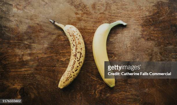 older and newer banana - fruit decay stockfoto's en -beelden