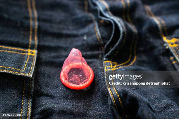 red condom on denim background,condoms - mens fashion wallpaper bildbanksfoton och bilder