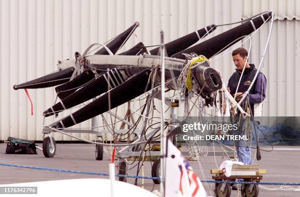 Member of Team Dennis Connors Stars & Stripes syndicate makes adjustments to one of their yacht masts at their base in the Viaduct Basin, Auckland,...