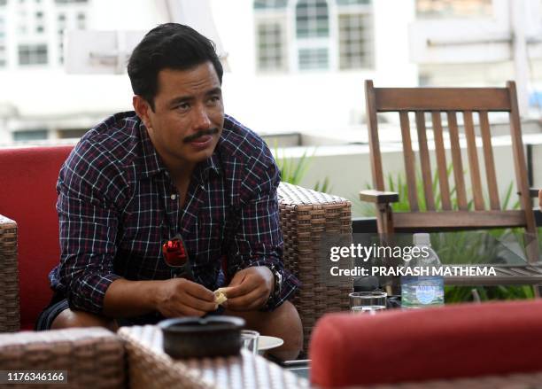 In this photo taken on October 16 Nepali mountaineer Nirmal Purja takes part in an interview with AFP in Kathmandu. - For pioneering Nepali...