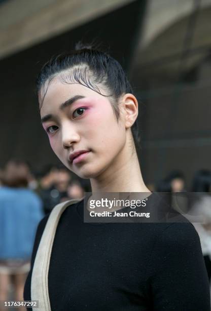 Guest wearing a black shirt is seen during the Seoul Fashion Week 2020 S/S at Dongdaemun Design Plaza on October 17, 2019 in Seoul, South Korea.
