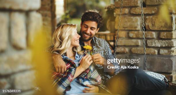 autumn love. - man giving flowers stock pictures, royalty-free photos & images