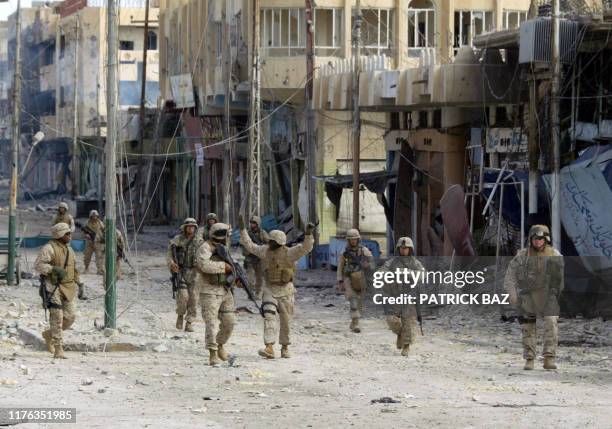 Marines from the 3/5 Lima company jubilate as they walk along the destroyed high street after taking the bridge in the restive city of Fallujah 14...