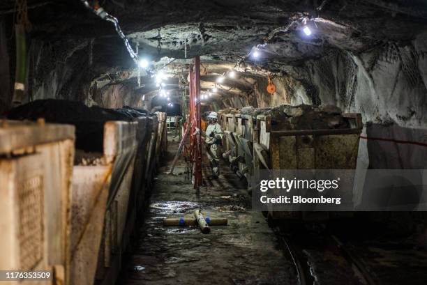 Mined platinum rich rock sits inside a freight wagon in the mine shaft during a media tour of the Sibanye-Stillwater Khuseleka platinum mine,...