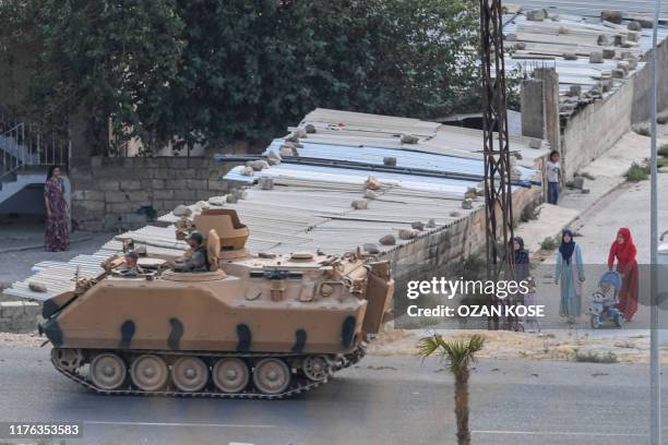 This picture taken on October 17, 2019 from the Turkish side of the border with Syria in the Ceylanpinar district city of Sanliurfa shows a Turkish...