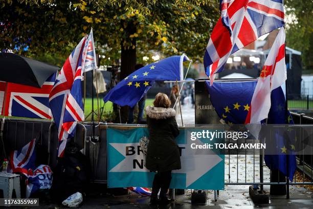 And Union flags are displayed outside the Houses of Parliament in Westminster, central London on October 17, 2019. - Britain's Prime Minister Boris...