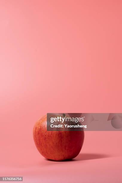 one red apple on pink background - green apple slices stock pictures, royalty-free photos & images