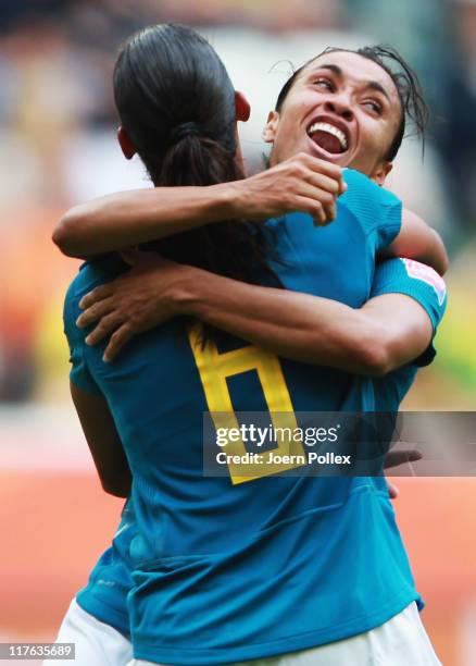 Rosana of Brazil celebrates with her team mate Marta after scoring her team's first goal during the FIFA Women's World Cup 2011 Group D match between...