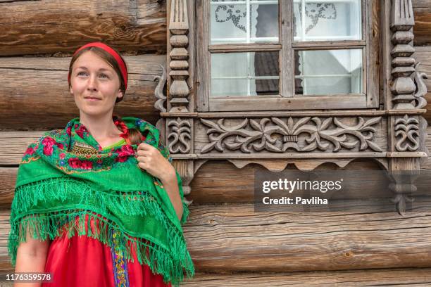 young woman in russian folk costume in front of window,western asia the urals in russia - russian theme village stock pictures, royalty-free photos & images