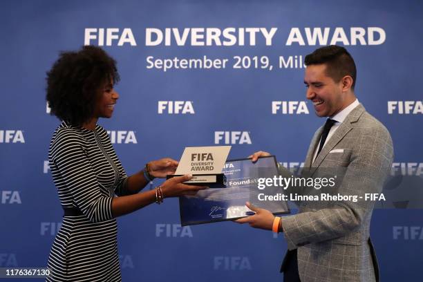 Laura Georges, Secretary General of the FFF delivers the FIFA Diversity Award 2019 winners trophy to Sergio Guerrero of Futbol Mas Foundation during...