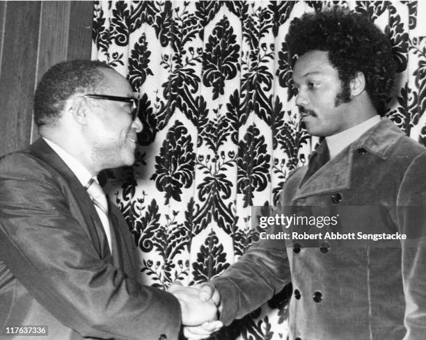 Chicago Defender publisher John H. Sengstacke , left, shakes the hand of civil rights activist Jesse Jackson at the Afro-American Patrolmen's League...