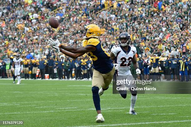 Marquez Valdes-Scantling of the Green Bay Packers scores a touchdown in the first quarter against Kareem Jackson of the Denver Broncos at Lambeau...