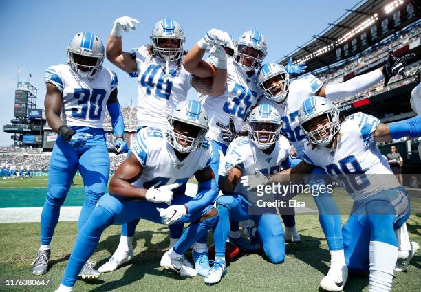 Jamal Agnew of the Detroit Lions celebrates his 100 yard kick off return for a touchdown with teammates Dee Virgin,Nick Bawden,C.J. Moore,Miles...