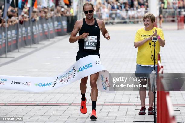 Philippe Viau-Dupuis of Canada wins the men's half marathon during Oasis International Marathon de Montreal - Day 2 on September 22, 2019 in...