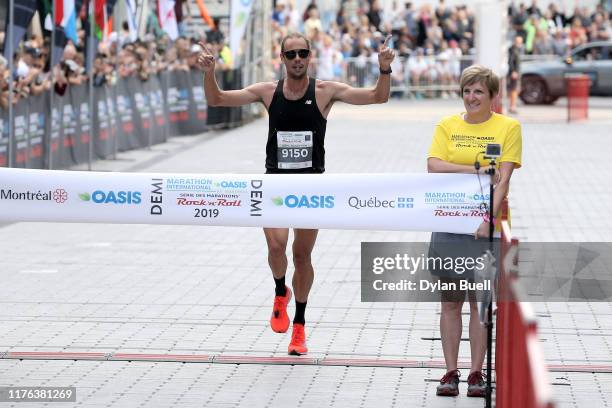 Philippe Viau-Dupuis of Canada wins the men's half marathon during Oasis International Marathon de Montreal - Day 2 on September 22, 2019 in...