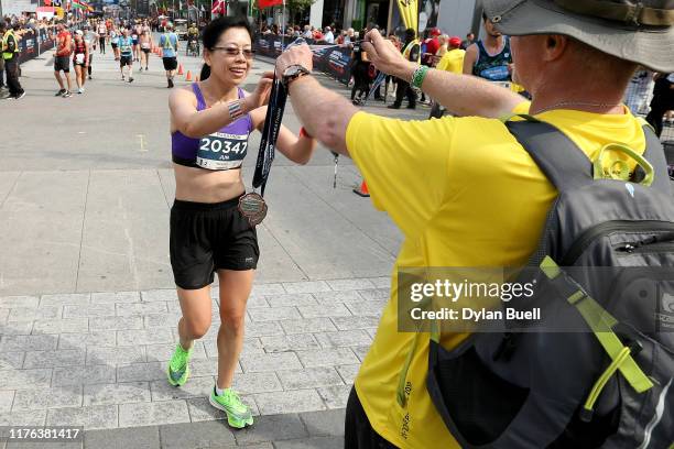 Runners receive their medals during Oasis International Marathon de Montreal - Day 2 on September 22, 2019 in Montreal, Canada.