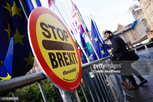 Stop Brexit' placard stands fixed to railings on Abingdon Street outside the Houses of Parliament in London, England, on October 17, 2019. Prime...