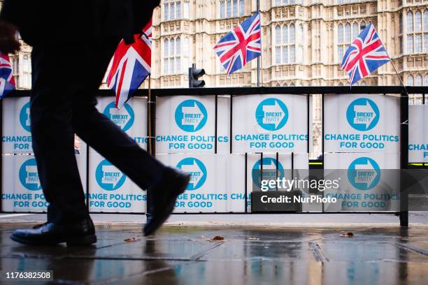 Man walks past placards for the Brexit Party fixed to railings on Abingdon Street outside the Houses of Parliament in London, England, on October 17,...