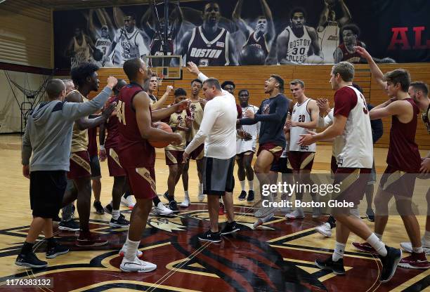 Boston College men's basketball head coach Jim Christian calls for a team high five after he delivered a pep talk during a practice session in the...