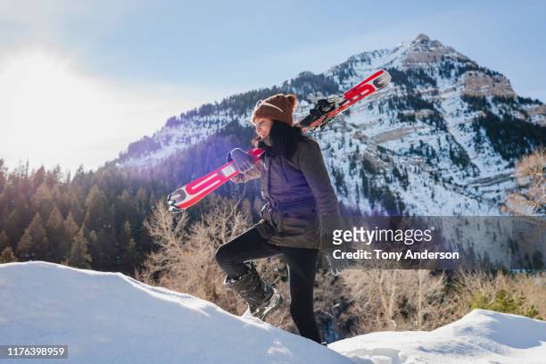 Young woman walking  with skis in winter mountains