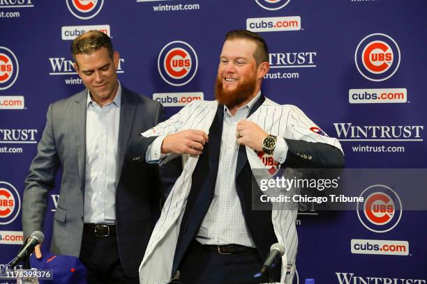 New Chicago Cubs pitcher Craig Kimbrel puts on his new jersey after being introduced by Chicago Cubs President Theo Epstein at Wrigley Field in...