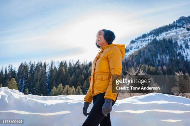 young woman outdoors in snowy mountains - winter coat stock pictures, royalty-free photos & images