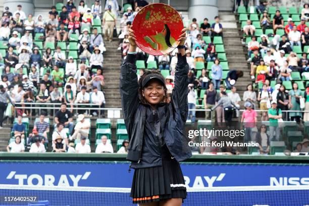 Singles champion Naomi Osaka of Japan poses for photographs with the trophy after the Singles final agains Anastasia Pavlyuchenkova of Russia during...