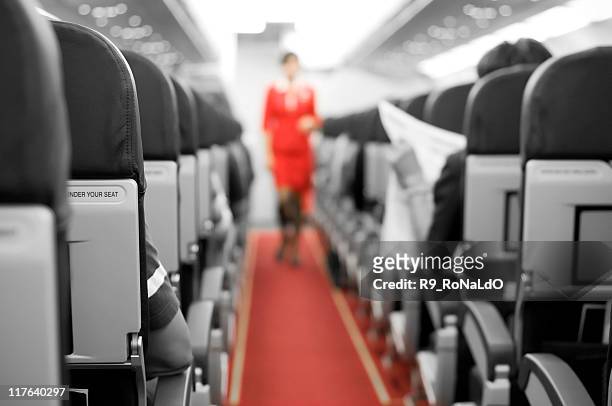 interior of an airplane with cabin crew in the background - 乘務員 個照片及圖片檔