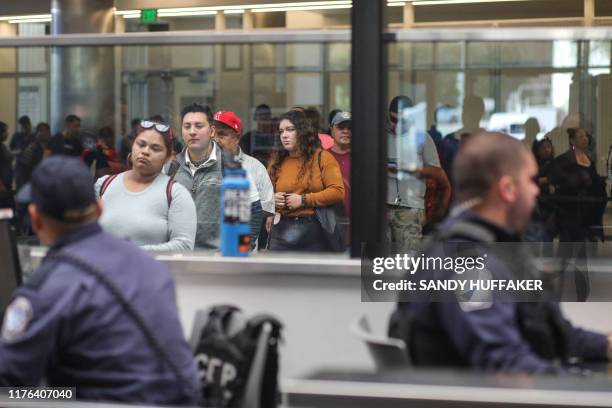 Customs and Border Protection agents check documents from pedestrians at the San Ysidro Port of Entry on October 2, 2019 in San Ysidro, California. -...