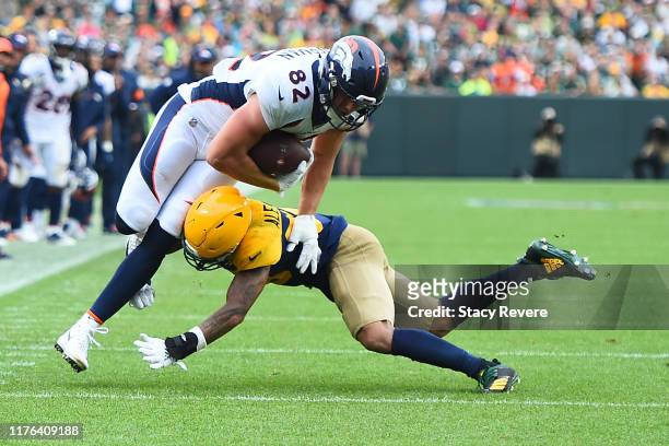 Jeff Heuerman of the Denver Broncos is brought down by Jaire Alexander of the Green Bay Packers during the second half at Lambeau Field on September...