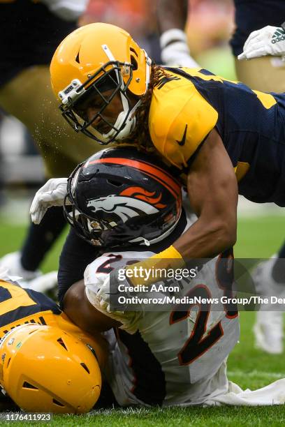 Tramon Williams of the Green Bay Packers and Blake Martinez stop Royce Freeman of the Denver Broncos during the second half of the Packers' 27-16 win...