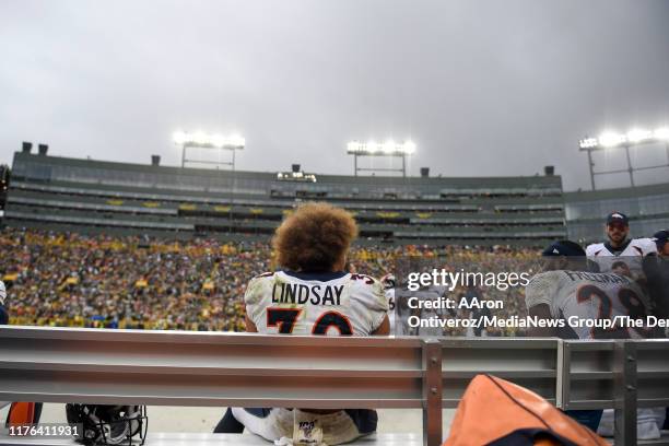 Phillip Lindsay of the Denver Broncos sits on the bench after scoring his second rushing touchdown against the Green Bay Packers during the second...