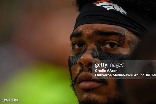 Elijah Wilkinson of the Denver Broncos sits on the bench as the defense attempts to stop the Green Bay Packers offense during the second half of the...