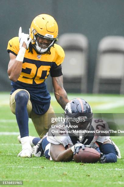 Kevin King of the Green Bay Packers wags a finger after stopping Royce Freeman of the Denver Broncos short of a first down on third down during the...