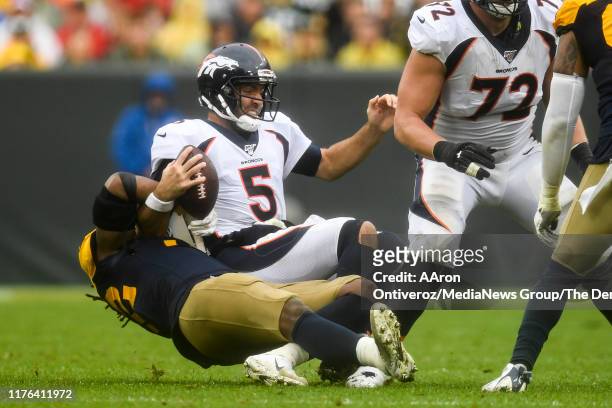 Rashan Gary of the Green Bay Packers sacks Joe Flacco of the Denver Broncos during the second half of the Packers' 27-16 win on Sunday, September 22,...